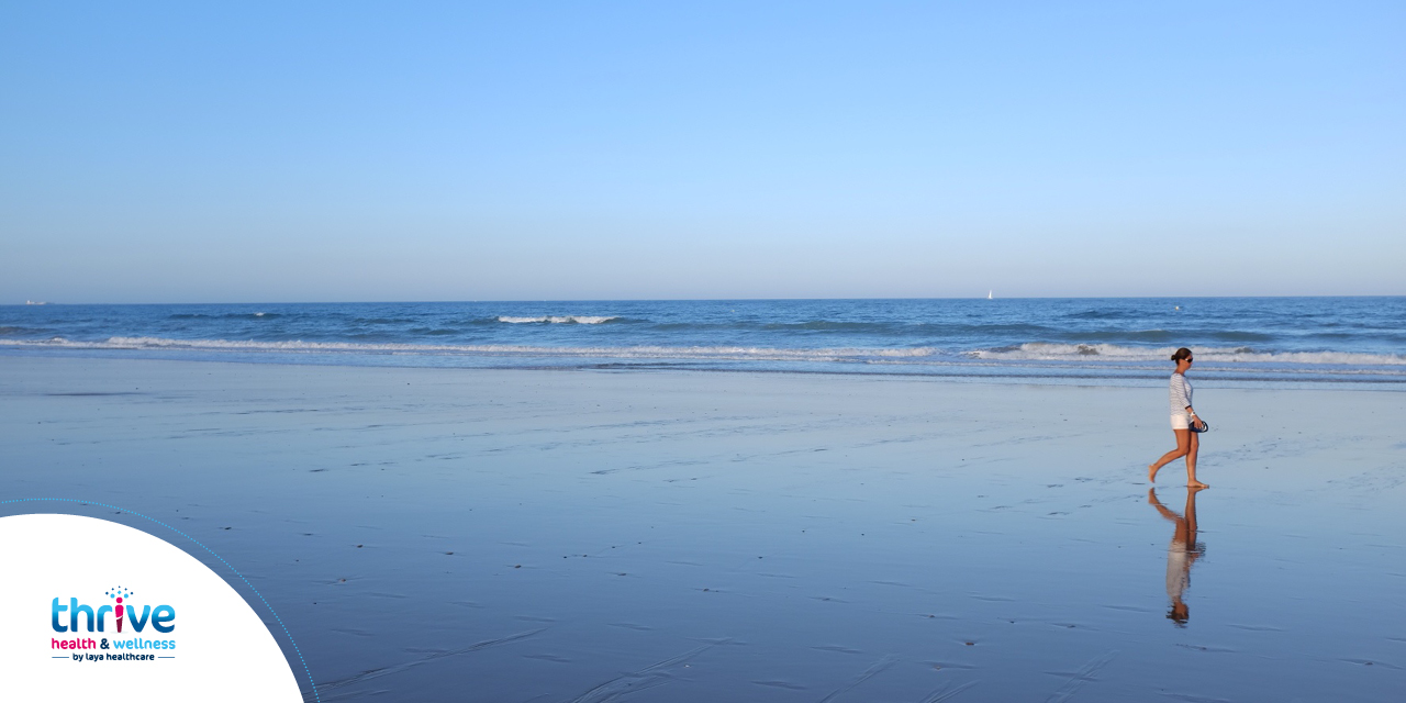 person walking along a beach