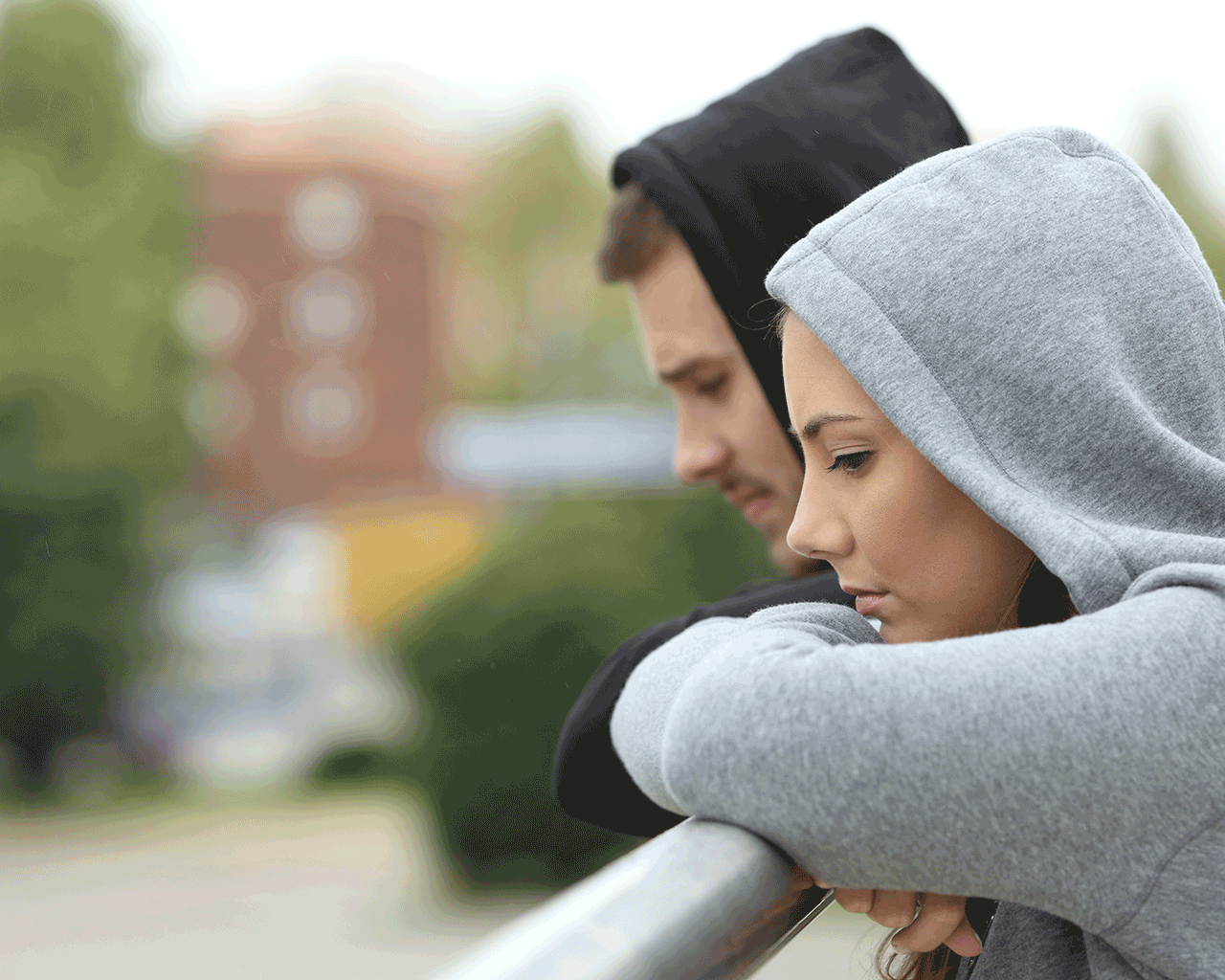 girl and boy looking over a wall