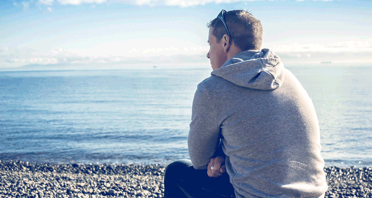 A man looks over a wall 