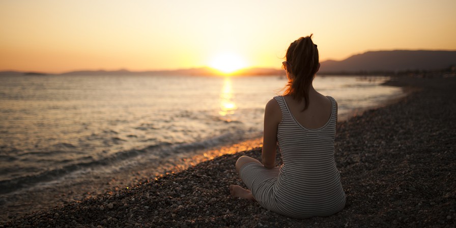 Woman watching sunset from beach