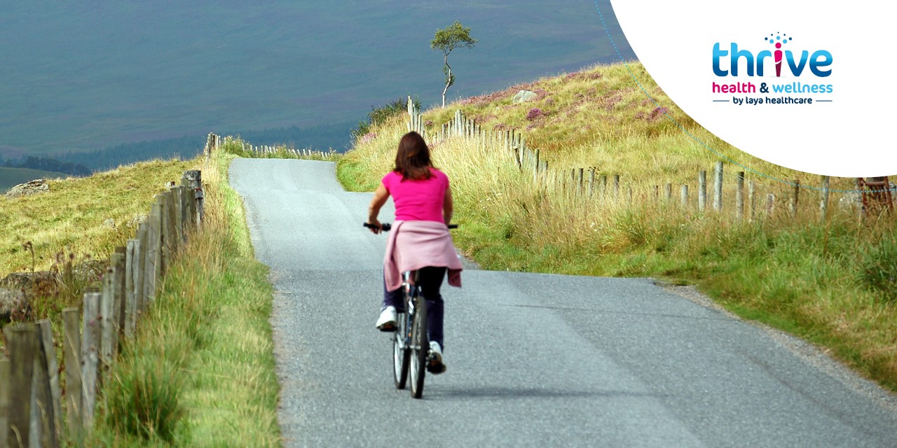 woman cycling a bike in the mountains