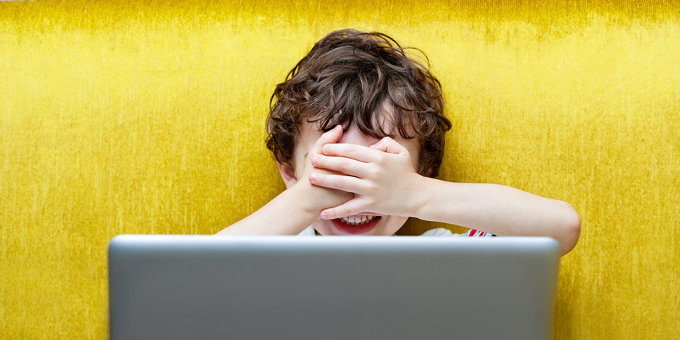 pic of a child hiding his eyes and a laptop