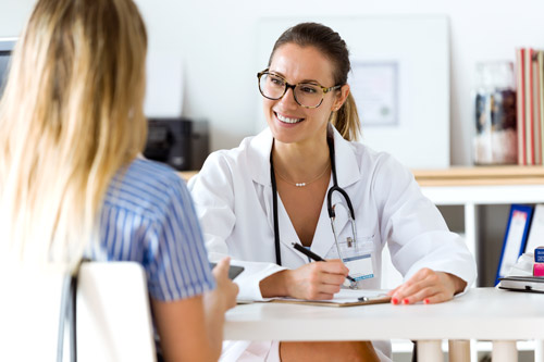 A consultant sitting with a patient