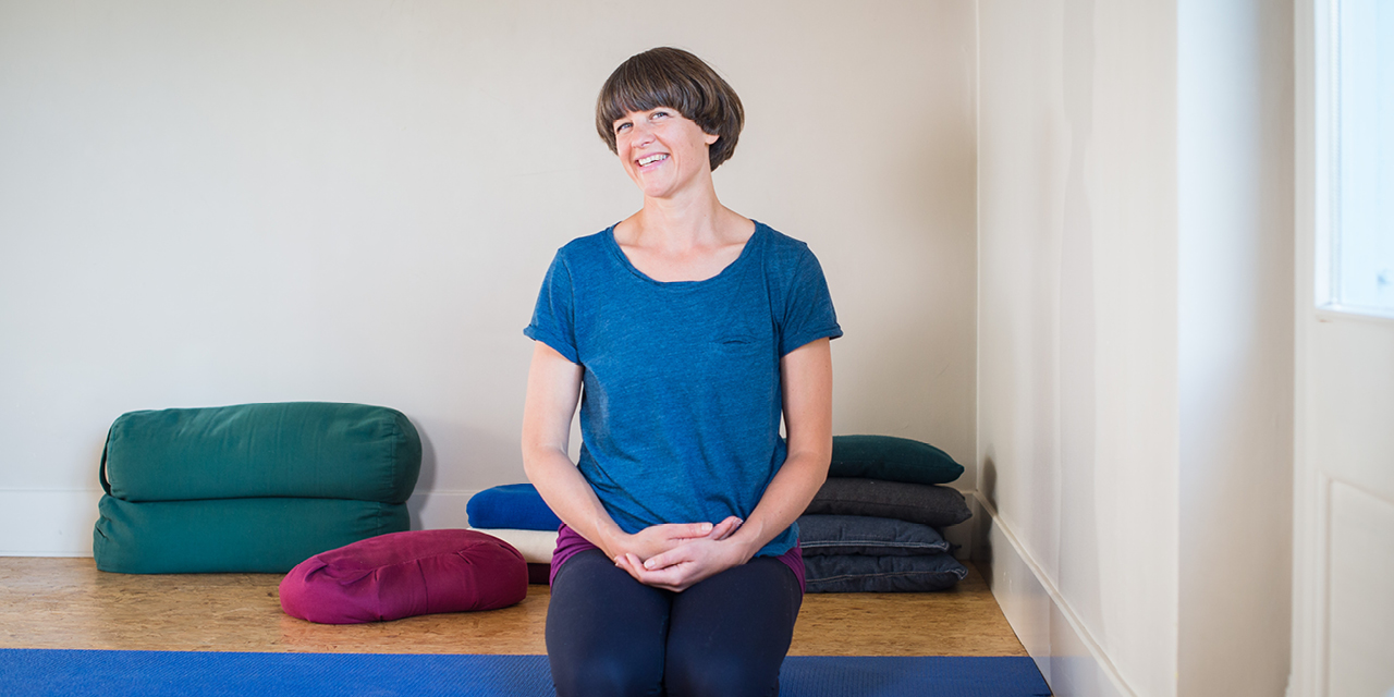 Jessica Hatchett in a blue top, with her hands clasped