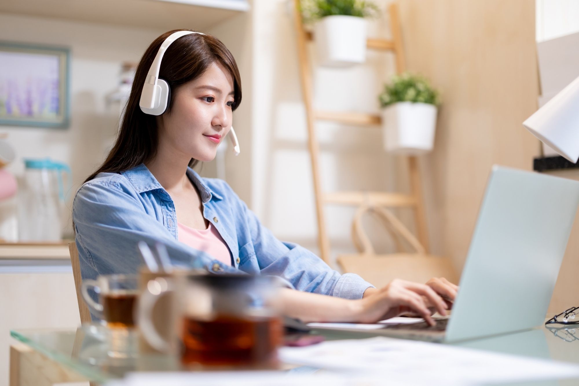 woman wearing headset working from a home office