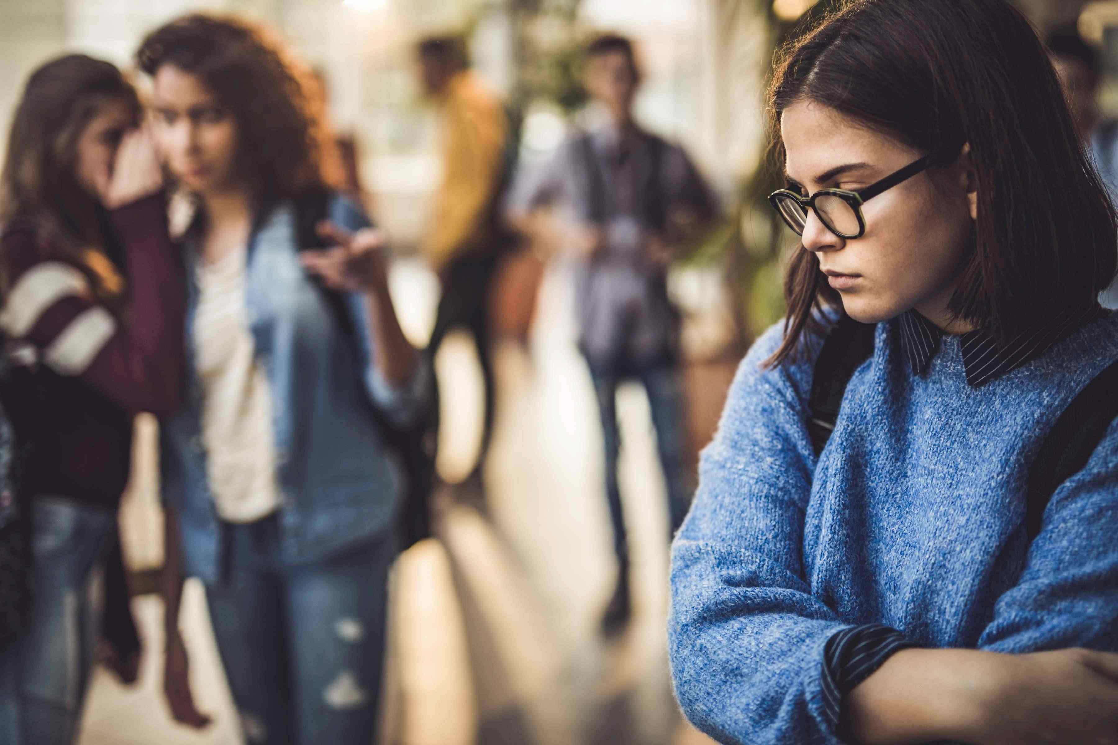 Lonely woman with glasses arms folded